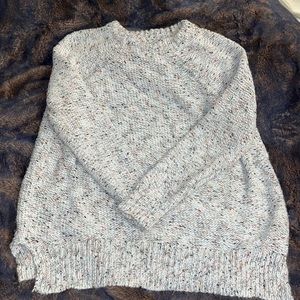 Size L cream colored knit sweater with red green and gold accent threads